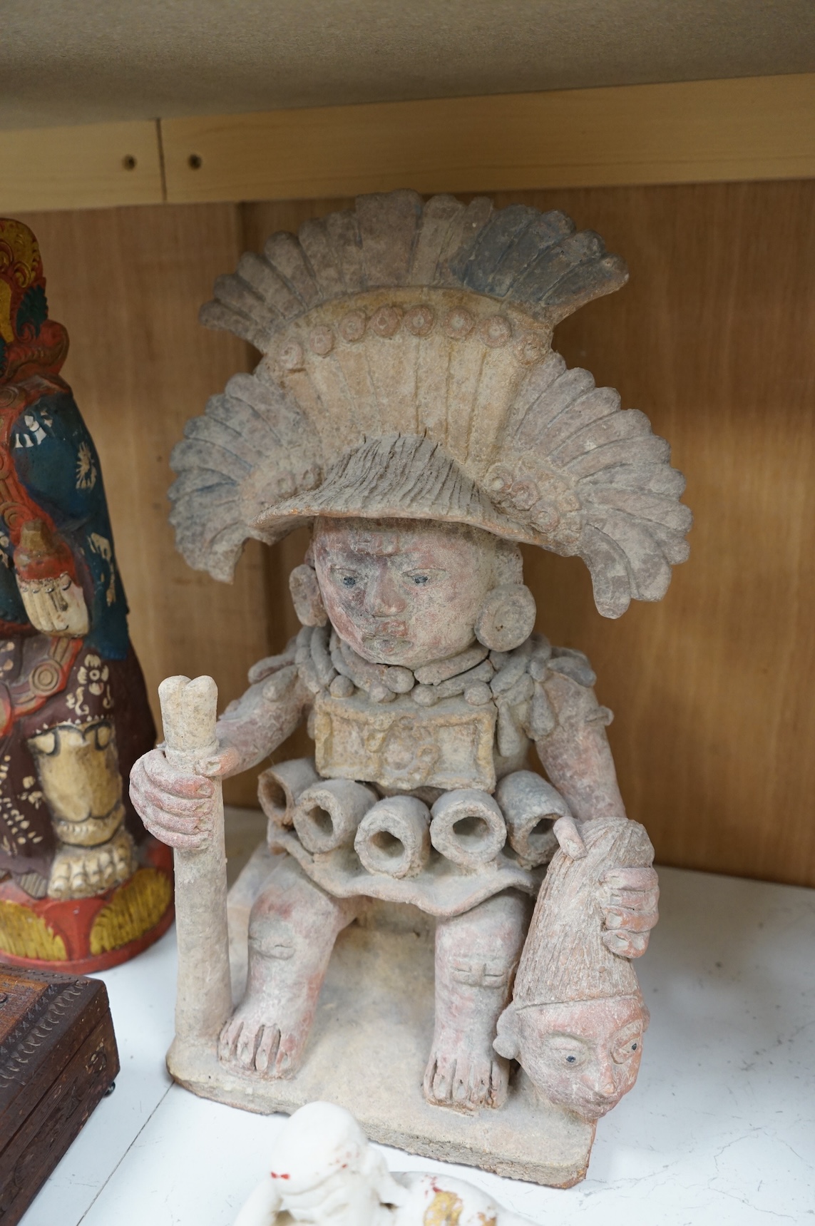 Eight south-east Asian carvings and a mounted bone, tallest 43cm